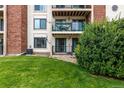 Backyard view of condo with patio, balcony and green space at 401 S Kalispell Way # 104, Aurora, CO 80017