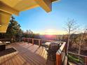 Expansive deck featuring outdoor seating and stunning sunset views over the mountains at 8 Sioux Trl, Evergreen, CO 80439