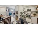 Bright kitchen featuring white cabinets, stainless steel appliances, and a dining area at 5300 E Cherry Creek South Drive # 918, Denver, CO 80246