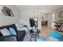 Comfortable living room with a dark leather sofa, TV and modern decor at 5300 E Cherry Creek South Drive # 918, Denver, CO 80246
