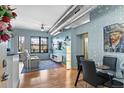Modern living room featuring a cozy gray sofa, a flatscreen TV, and industrial-style ductwork at 7700 E 29 Ave # 304, Denver, CO 80238