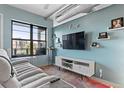 Cozy living room with large window, modern decor, and exposed ductwork offers a great view at 7700 E 29 Ave # 304, Denver, CO 80238