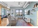 Bright living room boasts large windows, hard wood floors, modern decor, and exposed ductwork at 7700 E 29 Ave # 304, Denver, CO 80238