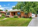 Charming red-brick home with a well-kept front lawn and a detached garage at 2240 S Clermont St, Denver, CO 80222