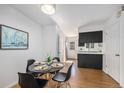 Inviting dining room with modern table set and adjacent updated kitchen space at 6774 S Independence St, Littleton, CO 80128