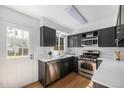 Updated kitchen with stainless steel appliances, white countertops and dark cabinetry, offering modern convenience at 6774 S Independence St, Littleton, CO 80128