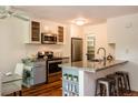 Well-lit kitchen with stainless steel appliances, granite countertops, and white cabinets at 827 Maxwell Ave # H, Boulder, CO 80304