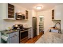 Kitchen boasts stainless steel appliances, granite countertops, subway tile backsplash, and walk-in pantry at 827 Maxwell Ave # H, Boulder, CO 80304