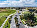 Stunning aerial view of a golf course community with lush greenery, well-maintained roads, and various amenities at 8101 S Quatar Cir, Aurora, CO 80016