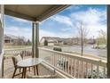 Cozy front porch with comfortable seating, offering a relaxing outdoor space with neighborhood views at 8101 S Quatar Cir, Aurora, CO 80016