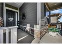 Charming front porch with stone accents, offering a welcoming entrance to this beautiful home at 8501 S Rome Way, Aurora, CO 80016