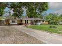 Attractive home featuring a long driveway, mature trees, and a charming brick exterior at 5810 S Greenwood St, Littleton, CO 80120