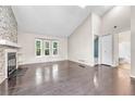 Spacious living room features wood floors, stone fireplace, and large windows providing ample natural light at 1148 S Ventura Cir # H, Aurora, CO 80017