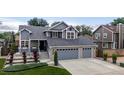 Beautiful two-story home with a two-car garage and a landscaped front yard under a cloudy sky at 6888 Howell St, Arvada, CO 80004