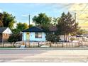 Charming home exterior with a yellow front door, fresh paint, and a quaint wood fence at 7799 Pecos St, Denver, CO 80221