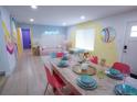 Open living space with modern dining, a cozy seating area, and colorful wall accents at 7799 Pecos St, Denver, CO 80221