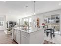 Bright, open kitchen featuring a granite island, stainless steel appliances, and adjacent dining area at 17825 Gallup St, Broomfield, CO 80023