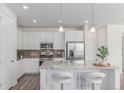 Well-equipped kitchen with granite counters, stainless appliances, and convenient breakfast bar at 17825 Gallup St, Broomfield, CO 80023