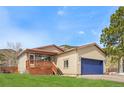Charming single Gathering house with a deck and an attached garage; beautiful lawn in front at 574 El Paso Rd, Palmer Lake, CO 80133