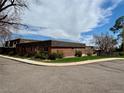 Exterior view of this charming brick home featuring a well-maintained lawn at 769 S Youngfield Ct, Lakewood, CO 80228