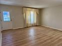 Bright and airy living room with beautiful flooring and a large window at 769 S Youngfield Ct, Lakewood, CO 80228