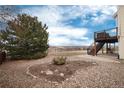 Spacious backyard featuring a two-story deck and professional landscaping at 7360 Almandine Ct, Castle Rock, CO 80108