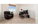 Bright office space with a work area and a large window offering a serene view at 7360 Almandine Ct, Castle Rock, CO 80108