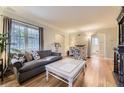 Cozy living room featuring hardwood floors, a large window, and comfortable seating at 1640 Pontiac St, Denver, CO 80220