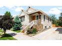 Charming home exterior with stone accents, landscaped front yard, and inviting entrance at 3320 Yukon Ct, Wheat Ridge, CO 80033
