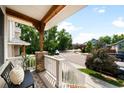 Relaxing front porch offering neighborhood views, stone columns, and comfortable seating at 3320 Yukon Ct, Wheat Ridge, CO 80033