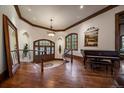 Elegant home foyer featuring wood floors, staircase, and a beautiful chandelier at 214 Equinox Dr, Castle Rock, CO 80108
