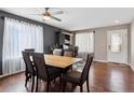 Inviting dining room with hardwood floors and large windows to provide natural light at 13818 Krameria St, Thornton, CO 80602