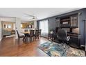 Inviting dining room with hardwood floors, a ceiling fan, and a built-in desk area at 13818 Krameria St, Thornton, CO 80602