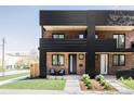 Striking exterior showcases a brick facade, black metal accents, and manicured landscaping at 2090 Eliot St, Denver, CO 80211