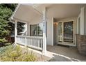 Front porch with white railing and entrance to the home at 11480 Moline St, Commerce City, CO 80640