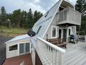 Spacious deck with mountain views, grill, and seating area at 4375 Tongue Rd, Indian Hills, CO 80454