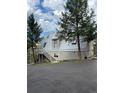 A-frame home with metal roof, deck, and paved driveway, nestled among trees at 4375 Tongue Rd, Indian Hills, CO 80454