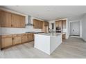 Spacious kitchen featuring a center island, wood cabinetry, and modern appliances at 25303 E Warren Pl, Aurora, CO 80018
