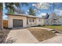 Charming single-story brick home with a well-maintained lawn, a walkway, and a one car garage at 4916 Knox Ct, Denver, CO 80221