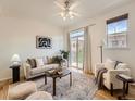 Bright living room with a sliding glass door to a balcony, a ceiling fan, and neutral decor at 5467 Zephyr Ct # 5467, Arvada, CO 80002
