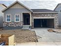 Charming single-story home featuring stone and gray siding, plus an attached two-car garage at 15286 Fillmore St, Thornton, CO 80602