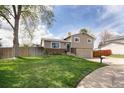 Beautiful exterior of a well-maintained home featuring a lush green lawn at 6141 S Estes St, Littleton, CO 80123