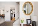 Bright foyer featuring modern decor, a decorative mirror, and views of the living spaces at 6141 S Estes St, Littleton, CO 80123