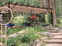 Backyard with a wood pergola, canvas roof, lighting, and hanging flowerpots at 8171 S Homesteader Dr, Morrison, CO 80465