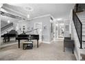 Open floor plan living room with a grand piano and neutral decor at 7201 E Quincy Ave # 102, Denver, CO 80237