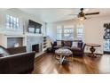 Inviting living room features hardwood floors, large windows, and a cozy fireplace at 3138 N Josephine St, Denver, CO 80205