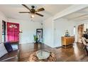 Stylish living room boasts hardwood floors, a vibrant pink door, and abundant natural light at 3138 N Josephine St, Denver, CO 80205