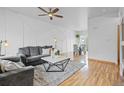 Comfortable living room with modern furniture, ceiling fan, and decorative wall paneling at 19216 E Idaho Pl # 102, Aurora, CO 80017