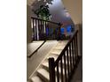 Elegant staircase featuring ambient lighting and dark wood banisters at 4526 Colorado River Dr, Firestone, CO 80504