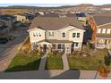 Panoramic aerial view of the lovely townhome showcasing the neighborhood and surrounding landscape at 3061 Low Meadow Blvd, Castle Rock, CO 80109